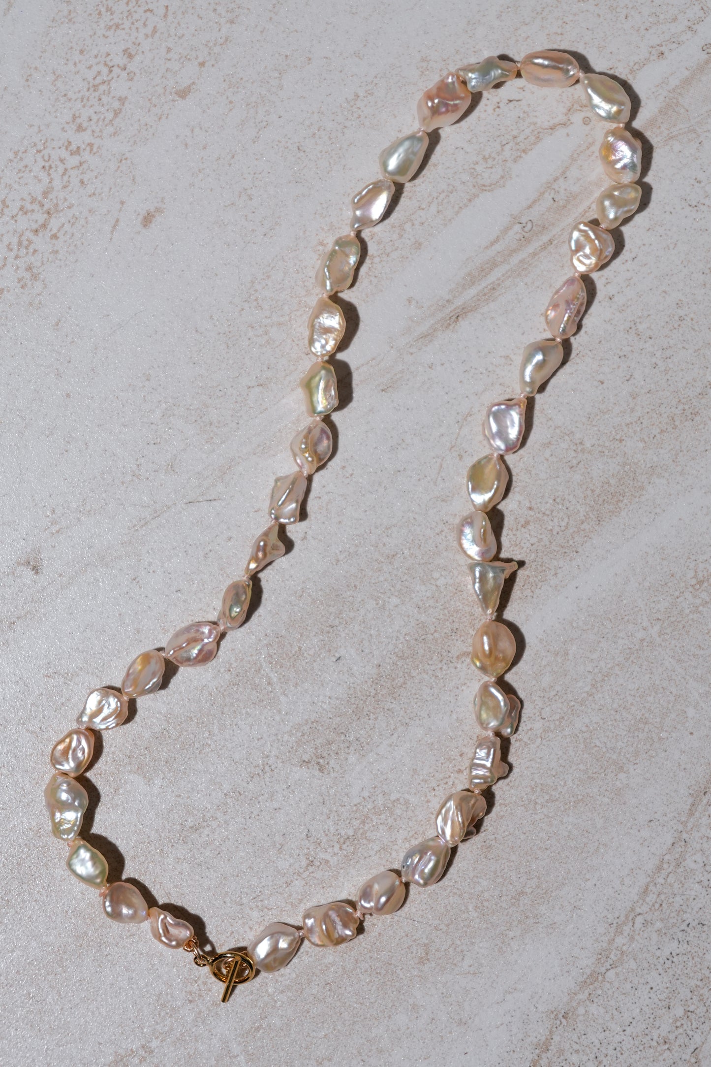 Peachy Keshi Pearl Knotted Necklace neutral background